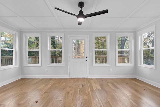 unfurnished sunroom featuring ceiling fan and a healthy amount of sunlight