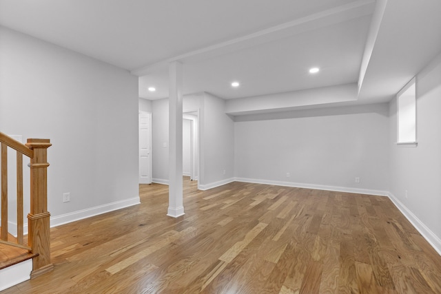 basement with light hardwood / wood-style flooring