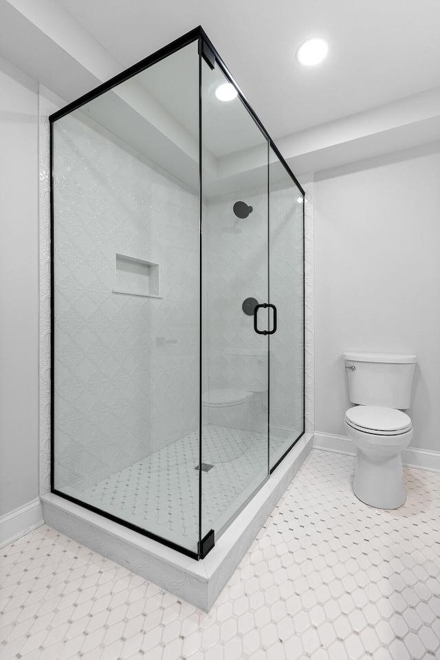 bathroom featuring walk in shower and toilet