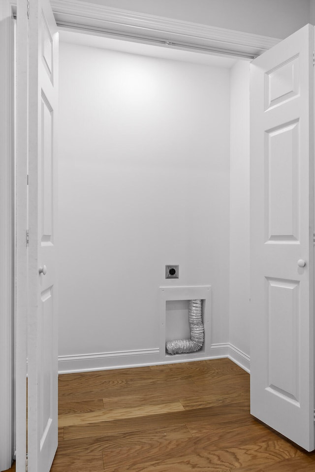 laundry room with electric dryer hookup and hardwood / wood-style flooring