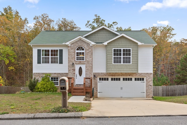 split foyer home featuring a garage and a front yard