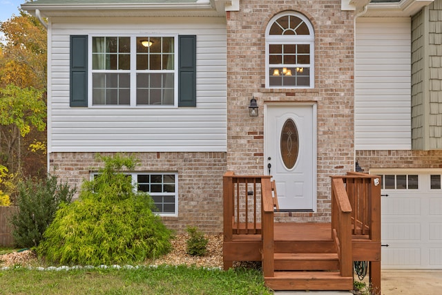 view of exterior entry featuring a garage