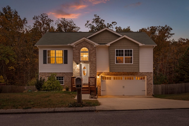 view of front of property with a lawn and a garage