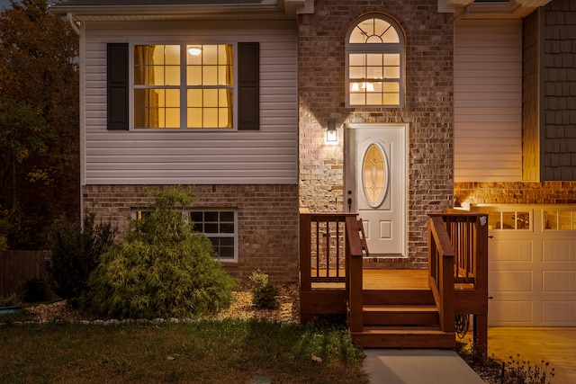 doorway to property with a garage