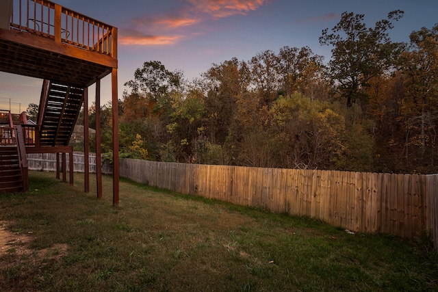 yard at dusk with a wooden deck