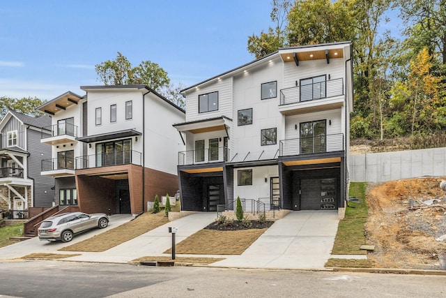 view of front of house featuring a garage and a balcony