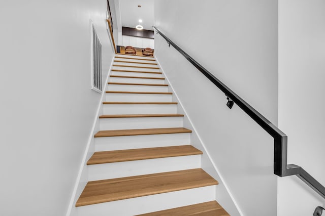 stairway featuring hardwood / wood-style floors