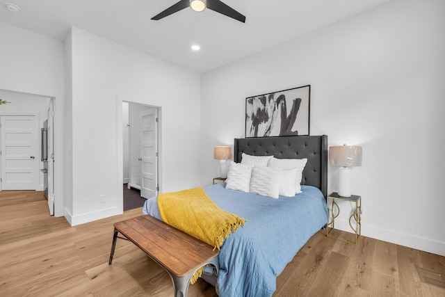 bedroom featuring ensuite bathroom, ceiling fan, and wood-type flooring