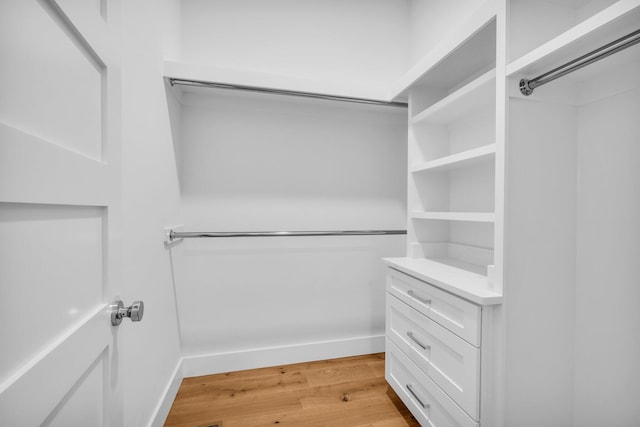 spacious closet with light hardwood / wood-style floors