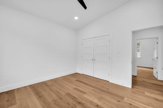 unfurnished bedroom with light hardwood / wood-style floors, ceiling fan, and lofted ceiling