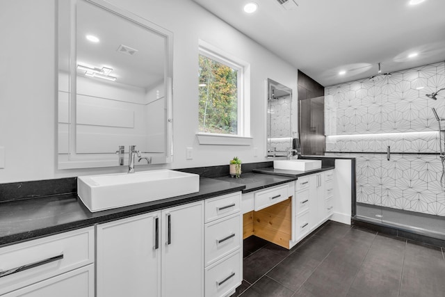 bathroom with vanity and tiled shower