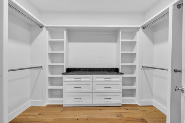 spacious closet featuring light hardwood / wood-style floors