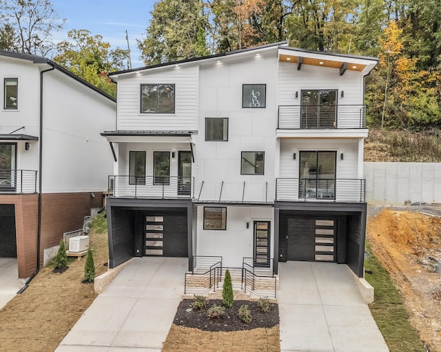 modern home featuring a balcony and a garage