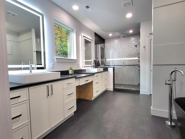 bathroom featuring vanity and tiled shower