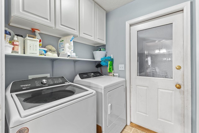 laundry area featuring independent washer and dryer and cabinets