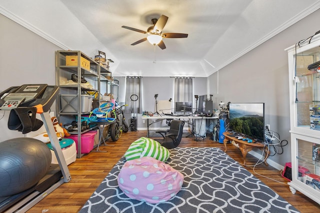 recreation room featuring lofted ceiling, hardwood / wood-style floors, ornamental molding, and ceiling fan