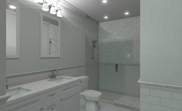 bathroom with tile patterned floors, toilet, tiled shower, vanity, and tile walls