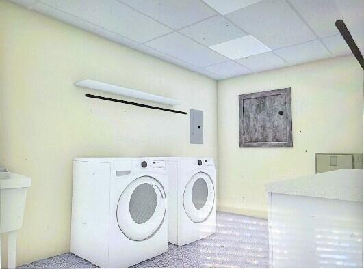 clothes washing area with electric panel, carpet floors, and independent washer and dryer