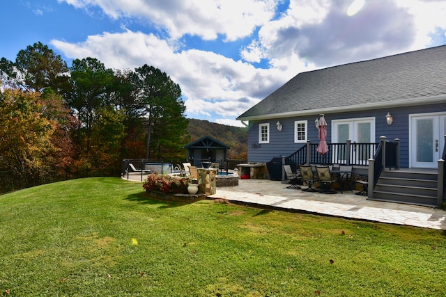 view of yard featuring a wooden deck and a patio area