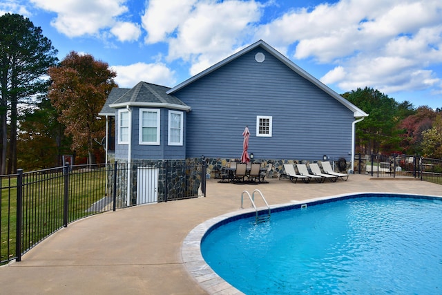 view of swimming pool with a lawn and a patio