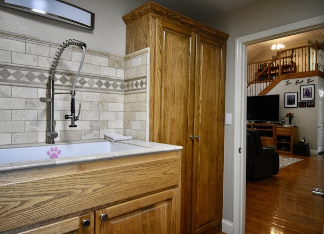 334 Belaire Dr, Copperhill, TN 37317 - kitchen with a sink, wood finished floors, brown cabinetry, a chandelier, and light countertops