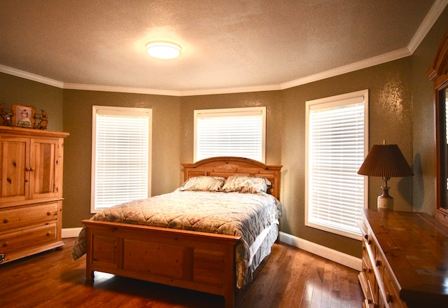 bedroom with ornamental molding, a textured ceiling, and dark hardwood / wood-style floors