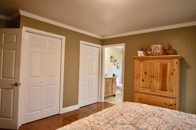 334 Belaire Dr, Copperhill, TN 37317 - bedroom featuring wood finished floors, ornamental molding, two closets, connected bathroom, and baseboards