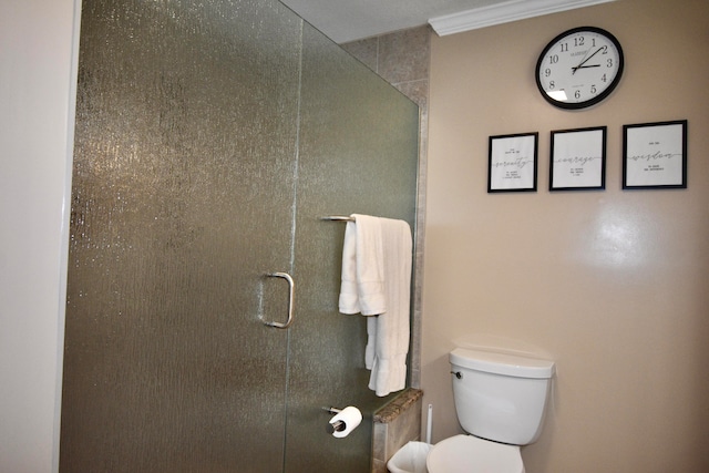 bathroom featuring walk in shower, toilet, and ornamental molding