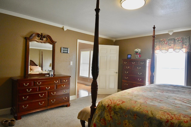 bedroom with ornamental molding and light carpet