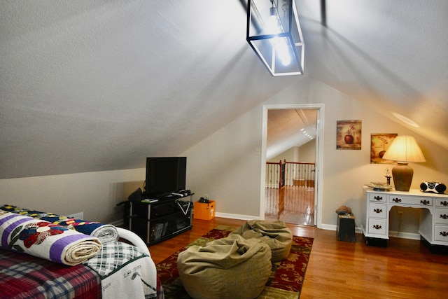 living room with hardwood / wood-style floors and lofted ceiling