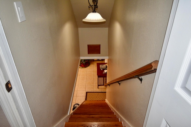 staircase with tile patterned floors