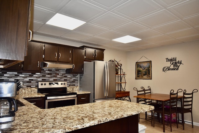334 Belaire Dr, Copperhill, TN 37317 - kitchen featuring stainless steel appliances, under cabinet range hood, decorative backsplash, dark brown cabinets, and light stone counters