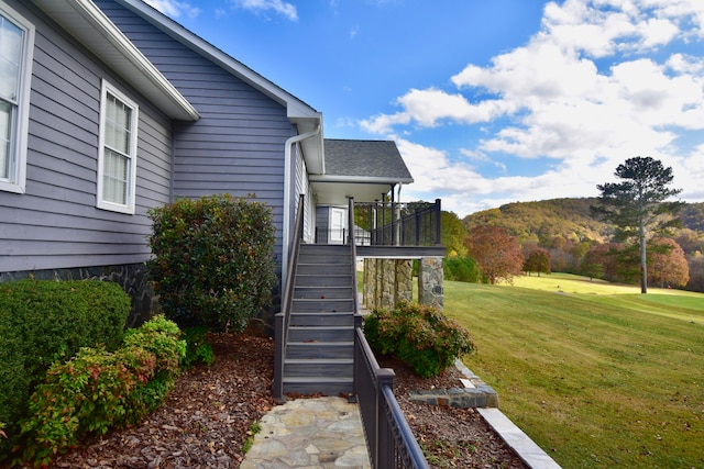 view of home's exterior featuring a mountain view and a lawn