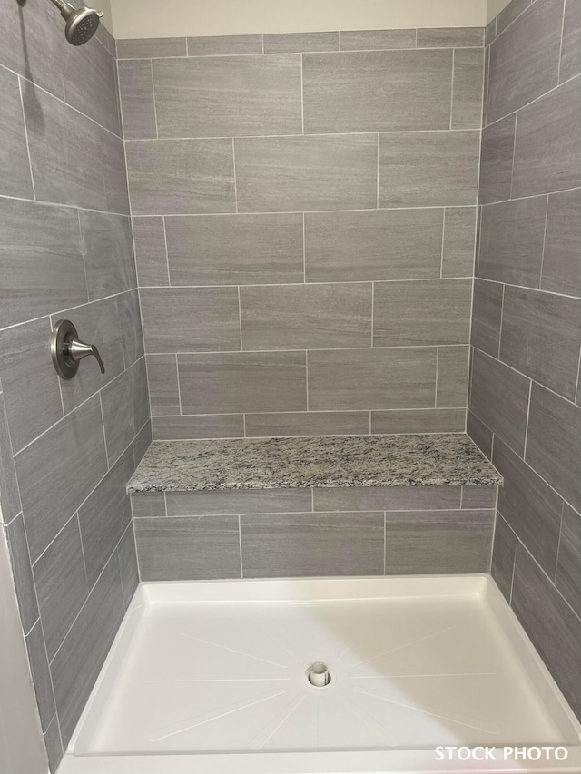 bathroom with a tile shower