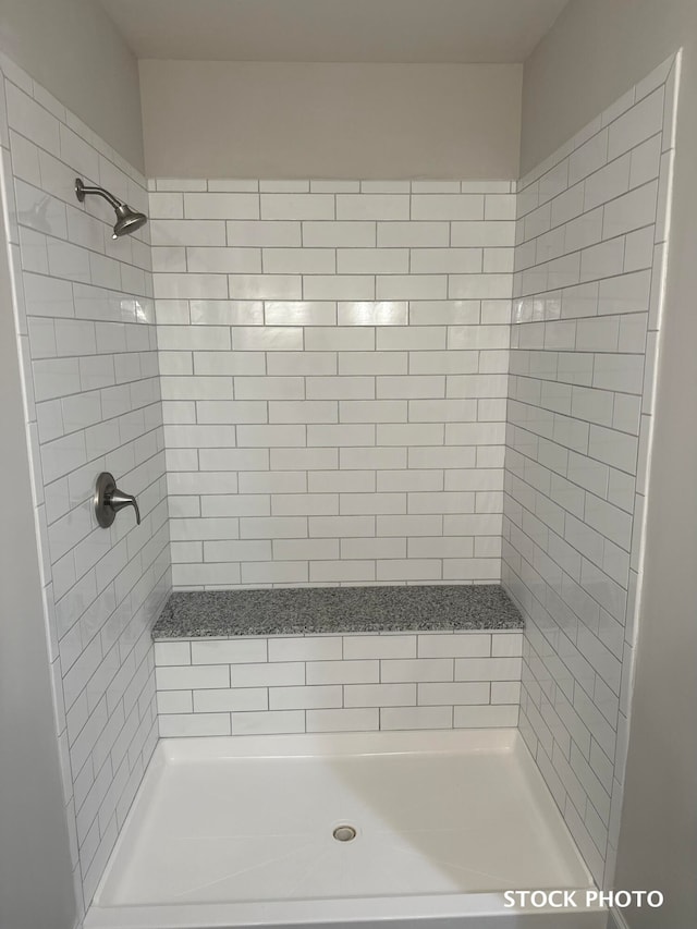 bathroom with tiled shower