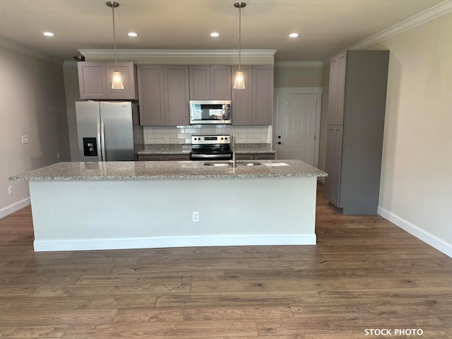 kitchen with gray cabinets, light stone countertops, decorative light fixtures, and appliances with stainless steel finishes