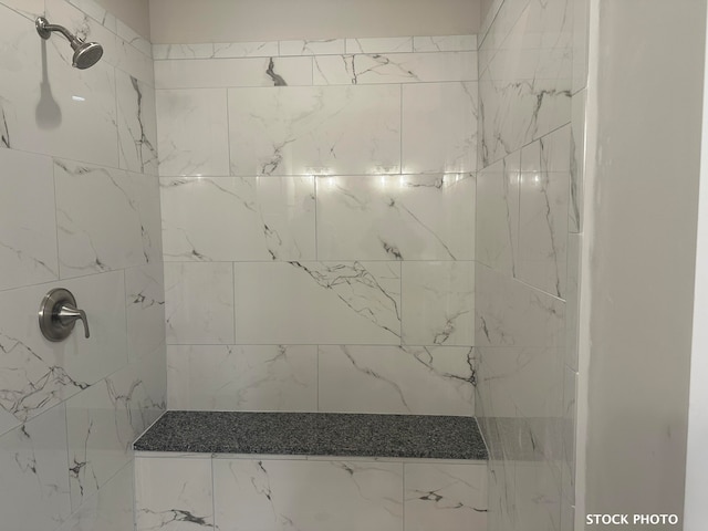 bathroom with a tile shower