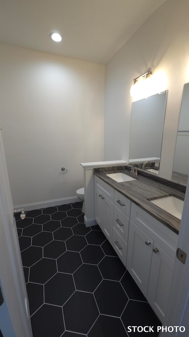 bathroom featuring tile patterned flooring, vanity, and toilet