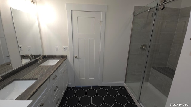 bathroom featuring an enclosed shower, vanity, and tile patterned floors