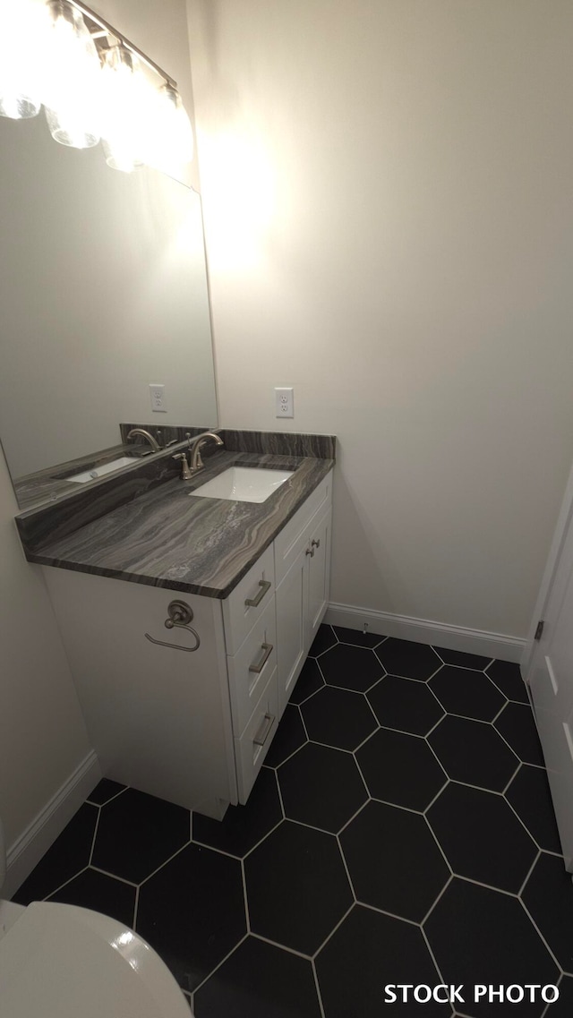 bathroom with tile patterned floors, vanity, and toilet