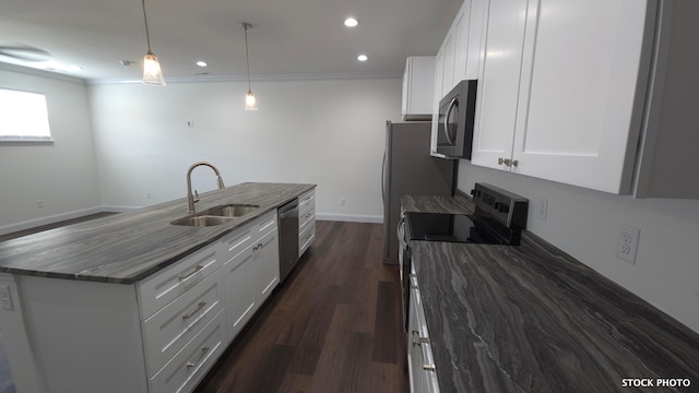 kitchen with stainless steel appliances, white cabinets, sink, and pendant lighting