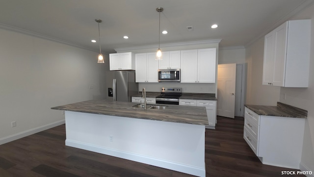 kitchen featuring stainless steel appliances, pendant lighting, white cabinets, dark wood-type flooring, and a kitchen island with sink