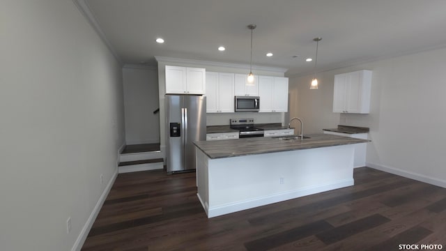 kitchen featuring white cabinetry, stainless steel appliances, hanging light fixtures, and sink