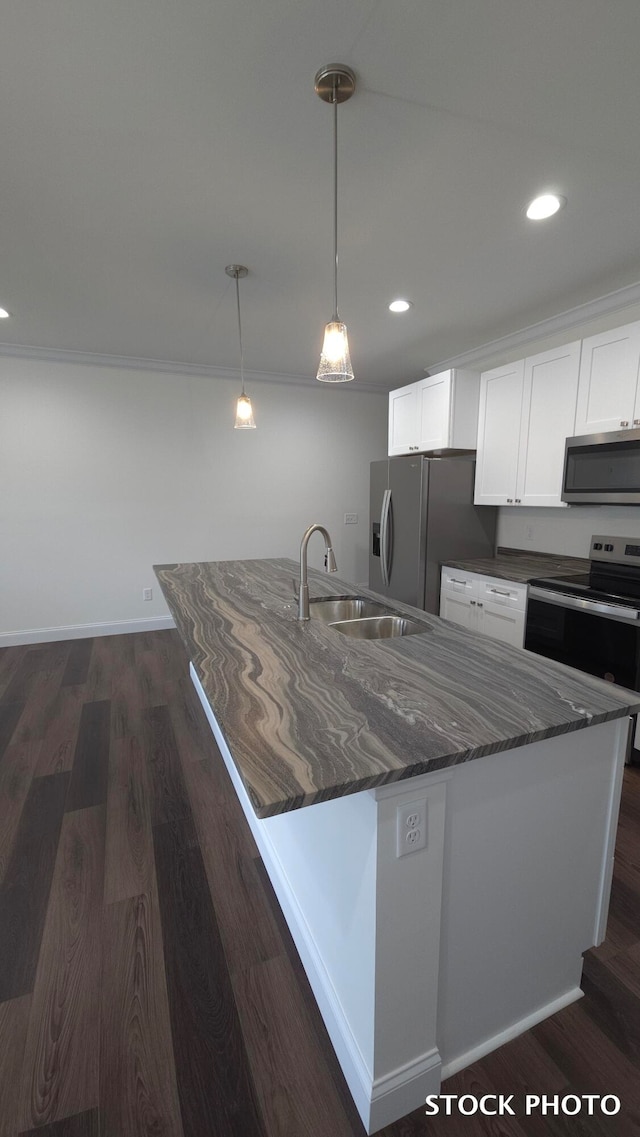 kitchen featuring stainless steel appliances, white cabinets, sink, dark hardwood / wood-style floors, and pendant lighting