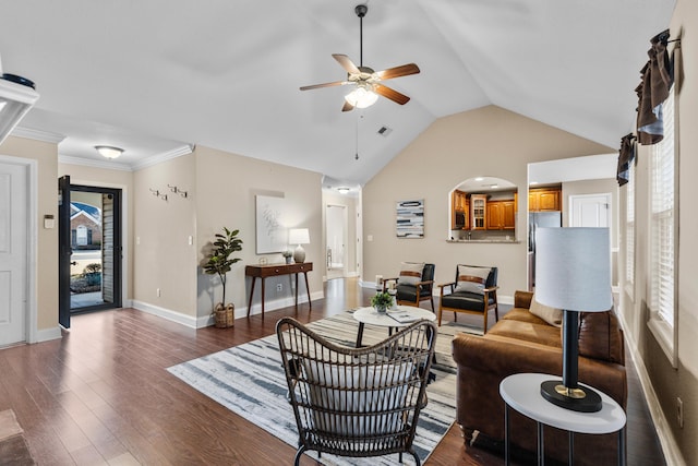 living room featuring dark wood-type flooring, ceiling fan, lofted ceiling, and crown molding