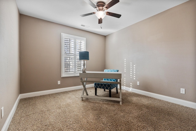 carpeted home office featuring ceiling fan