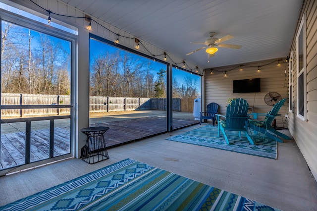 unfurnished sunroom with plenty of natural light and ceiling fan