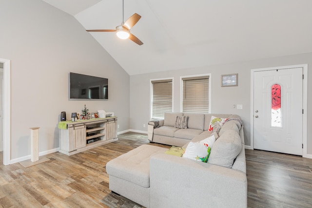 living room with hardwood / wood-style floors, ceiling fan, and high vaulted ceiling