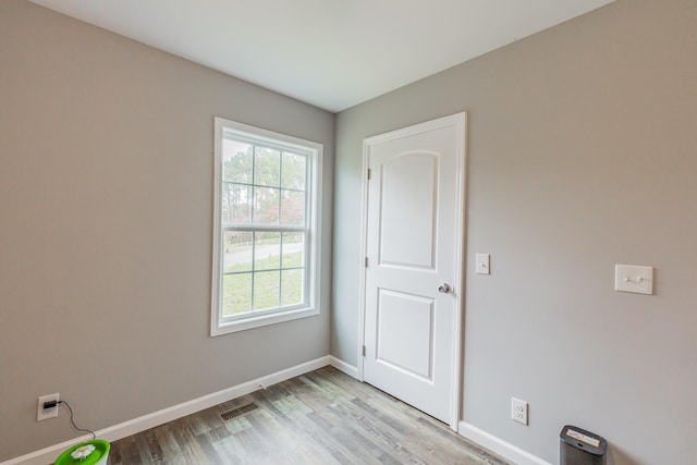 empty room with light hardwood / wood-style flooring