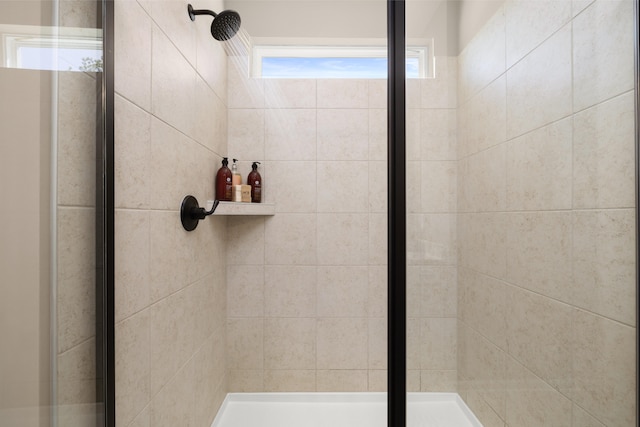 bathroom with a shower with door